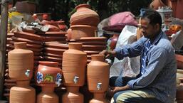A potter arranging earthen pots at his road side shop in Maloya village, Chandigarh. (Ravi Kumar/ HT)