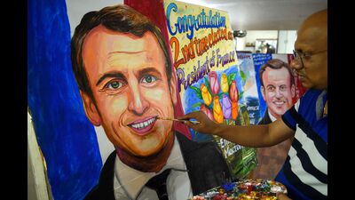 An artist gives final touches to a painting of French President and La Republique en Marche (LREM) party candidate for re-election Emmanuel Macron after his victory in France's presidential election, in Mumbai on April 25, 2022. (Photo by Punit PARANJPE / AFP) (AFP) An artist gives final touches to a painting of French President and La Republique en Marche (LREM) party candidate for re-election Emmanuel Macron after his victory in France's presidential election, in Mumbai on April 25, 2022. (Photo by Punit PARANJPE / AFP) (AFP)