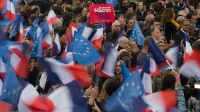 Supporters of Emmanuel Macron, France's president, celebrate following the second round of voting in the French presidential election. Macron is the first French president in two decades to win a second term, but his latest victory over his far-right rival was narrower than their last face-off in 2017, when the margin was 66.1 percent to 33.9 percent. (Bloomberg) Supporters of Emmanuel Macron, France's president, celebrate following the second round of voting in the French presidential election. Macron is the first French president in two decades to win a second term, but his latest victory over his far-right rival was narrower than their last face-off in 2017, when the margin was 66.1 percent to 33.9 percent. (Bloomberg)