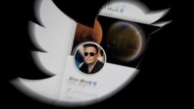 Elon Musk's account is seen through Twitter logo in this illustration.&nbsp; (REUTERS)