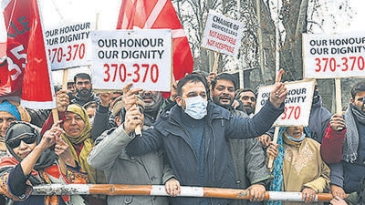 Activists of National Conference shout slogans and hold placards during a protest against the delimitation commission in Srinagar, Jammu and Kashmir, India on Saturday, January 1, 2022. (Photo by Waseem Andrabi/Hindustan Times)