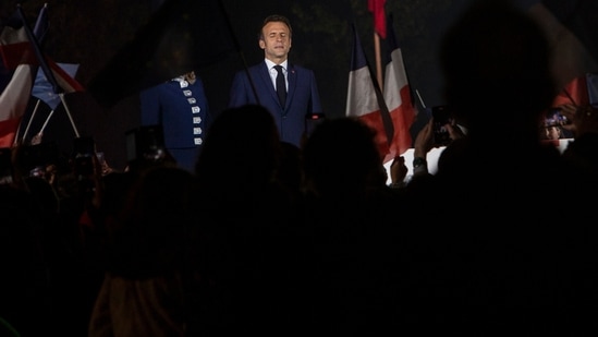 French President Emmanuel Macron celebrates with supporters in front of the Eiffel Tower Paris, France, Sunday, April 24, 2022.&nbsp;(AP)