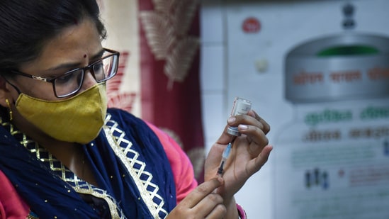 A healthworker fills a syringe with a dose of Covid-19 vaccine before administering it to a beneficiary, in New Delhi.&nbsp;(PTI)