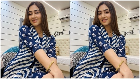 The Bade Achhe Lagte Hain 2 actor's suit set features a matching kurti and pants decorated with floral patterns in a white hue. The top features a round neckline, three-fourth sleeves and a breezy silhouette. Disha rounded off the ensemble with a blue and white striped printed dupatta draped on her neck.(Instagram/@dishaparmar)