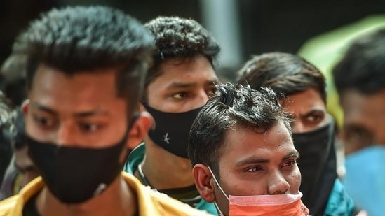 Passengers wearing face masks stand in a queue for Covid-19 test at Krantiveer Sangoli Rayanna railway station in Bengaluru (PTI) Passengers wearing face masks stand in a queue for Covid-19 test at Krantiveer Sangoli Rayanna railway station in Bengaluru (PTI)