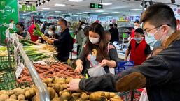 Customers wearing masks shop at the vegetables section of a supermarket following Covid-19 outbreak in Beijing, China, on Tuesday. (REUTERS)