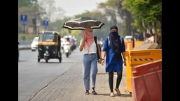 Women seen using scarves and umbrellas to protect themselves from the heat. (HT PHOTO)