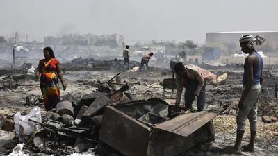 Gurugram, India - April. 26, 2022: People salvage charred belongings from a site were a massive fire erupted in a garbage pile, near Kankrola village in Sector 6, Industrial Model Township (IMT) Manesar, in Gurugram, India, on Tuesday, April 26, 2022. One dead, three injured in the fire incident that gutted many shanties according to the reports. (Photo by Vipin Kumar/ Hindustan Times) (Vipin Kumar/HT PHOTO) Gurugram, India - April. 26, 2022: People salvage charred belongings from a site were a massive fire erupted in a garbage pile, near Kankrola village in Sector 6, Industrial Model Township (IMT) Manesar, in Gurugram, India, on Tuesday, April 26, 2022. One dead, three injured in the fire incident that gutted many shanties according to the reports. (Photo by Vipin Kumar/ Hindustan Times) (Vipin Kumar/HT PHOTO)