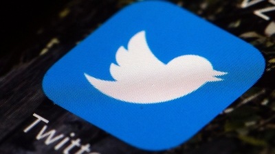 The Twitter icon is displayed on a mobile phone (AP)