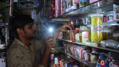 A shopkeeper can be seen using mobile light in Thane because of electricity cut (Praful Gangurde/HT photos) A shopkeeper can be seen using mobile light in Thane because of electricity cut (Praful Gangurde/HT photos)