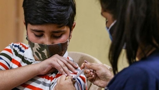 A healthcare worker administers a dose of the Corbevax vaccine to a child in the age group of 12-15 years in New Delhi. (HT PHOTO)