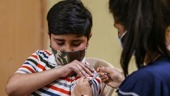 A healthcare worker administers a dose of the Corbevax vaccine to a child. (HT file photo)