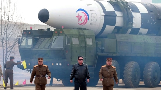 This picture shows North Korean leader Kim Jong Un (C) walking near what state media report says a new type inter-continental ballistic missile (ICBM).(AFP)