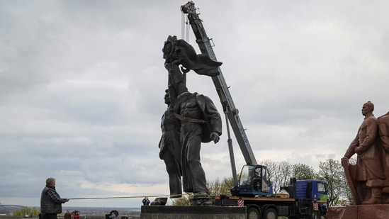 A Soviet monument to a friendship between Ukrainian and Russian nations is seen during its demolition, amid Russia's invasion of Ukraine, in central Kyiv.