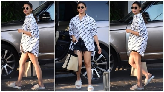 Alia Bhatt arrives at the airport in an oversized shirt and distressed shorts. (HT Photo/Varinder Chawla)