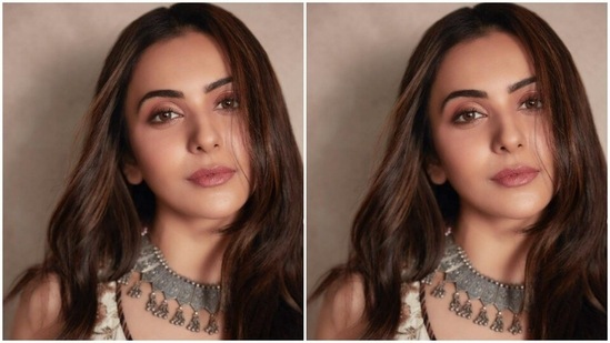 Rakul Preet paired an ivory white sleeveless bralette with a high-waisted ivory white lehenga. The bralette featured gota work in soft maroon resham threads. The skirt features a maroon belt detail at the waist and maroon borders near the ankles.(Instagram/@rakulpreet)