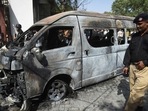 Police inspect a site around damaged vehicles following a suicide bombing near the Confucious Institute affiliated with the Karachi University. (AFP) Police inspect a site around damaged vehicles following a suicide bombing near the Confucious Institute affiliated with the Karachi University. (AFP)