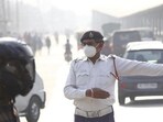 A traffic police personnel wearing anti-air pollution mask, at Hero Honda Chowk, in Gurugram. (Yogendra Kumar/HT FILE PHOTO)