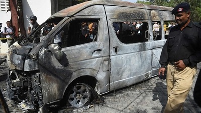 Police inspect a site around damaged vehicles following a suicide bombing near the Confucious Institute affiliated with the Karachi University. (AFP) Police inspect a site around damaged vehicles following a suicide bombing near the Confucious Institute affiliated with the Karachi University. (AFP)