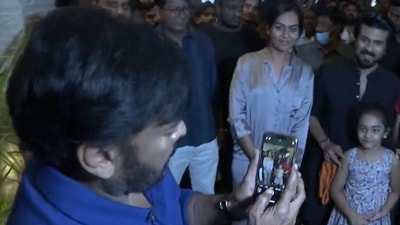 Chiranjeevi clicks son Ram Charan's pic with fans. Chiranjeevi clicks son Ram Charan's pic with fans.