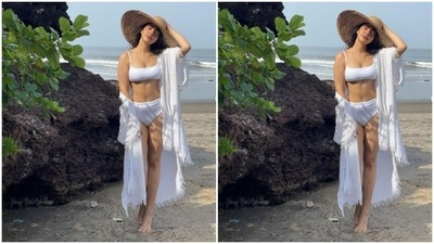 Neha Sharma wore this stunning white bikini while she was on a vacation in Goa. She teamed her swimwear with a white cape and a bamboo sunhat. (Instagram/@nehasharmaofficial)