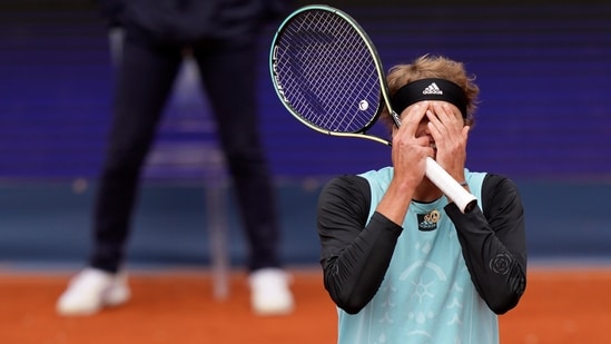 Alexander Zverev of Germany covers his face during his first round match against Holger Rune of Denmark(AP)