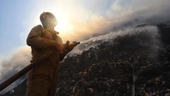 "We received a call at around 5.47 pm. Initially, there was only smoke but later due to wind fire erupted. 12 fire tenders are present at the spot. Our aim is to ensure that fire does not spread to residential areas," said, CL Meena, Assistant Divisional Officer, Delhi Fire Service.(HT Photo/Sanchit Khanna)