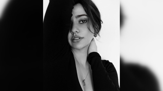 Neha Sharma tied her hair in a messy bun with some strands framing her face and aced the no makeup look.(Instagram/@nehasharmaofficial)