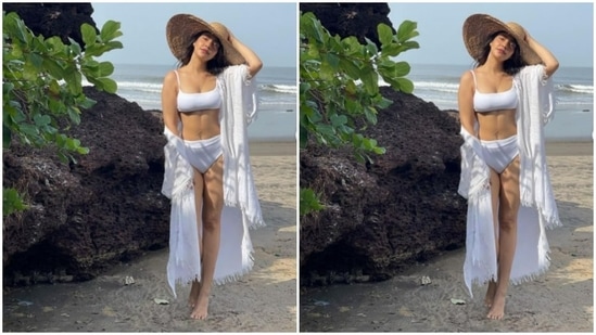 Neha Sharma wore this stunning white bikini while she was on a vacation in Goa. She teamed her swimwear with a white cape and a bamboo sunhat.(Instagram/@nehasharmaofficial)