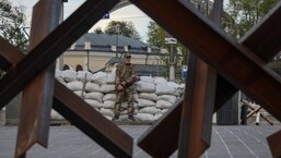 A serviceman stands guard next to anti-tank constructions, amid Russia's invasion of Ukraine, in central Kyiv, Ukraine.