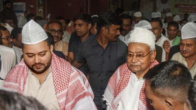 Bihar chief minister Nitish Kumar with RJD leader Tejashwi Yadav during an Iftar party hosted by Janata Dal (United) at Haj Bhawan in Patna (PTI)
