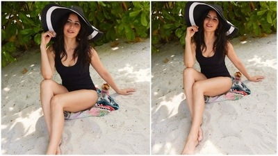 Katrina Kaif also shared a photo of herself in a black monokini which she accessorised with black and white sun hat. (Instagram/@katrinakaif)