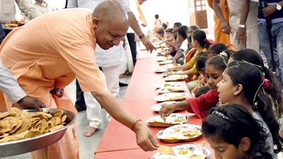 Uttar Pradesh chief minister Yogi Adityanath distributes food during kumari puja in Gorakhpur. (ANI file)