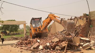 Ghaziabad, India - April 28, 2022: An excavator demolishes the alleged illegal property of Samajwadi Party (SP) leader Usman Chaudhary at Usman Garhi in Ghaziabad, Uttar Pradesh, India on Thursday, April 28 2022. (Photo by Sakib Ali/Hindustan Times) Ghaziabad, India - April 28, 2022: An excavator demolishes the alleged illegal property of Samajwadi Party (SP) leader Usman Chaudhary at Usman Garhi in Ghaziabad, Uttar Pradesh, India on Thursday, April 28 2022. (Photo by Sakib Ali/Hindustan Times)