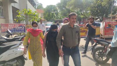 The accused woman student (C ) in police custody in Amritsar. She was arrested on Thursday along two others with a consignment of heroin. (HT Photo)
