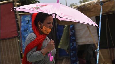 Gurugram, India - April. 28, 2022: A woman walks under the shade of her umbrella in the midst of an ongoing heat wave in Gurugram, India, on Thursday, April 28, 2022. (Photo by Vipin Kumar/ Hindustan Times) (Vipin Kumar/HT PHOTO)