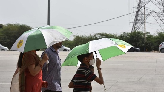 A family carries umbrellas on a hot summer day in Gurugram, India (Photo by Vipin Kumar/ Hindustan Times) (Vipin Kumar/HT PHOTO)