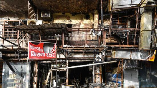 A view of the charred remains of a building that caught fire in Amar Colony, New Delhi, on Tuesday. (Amal KS/HT Photo)