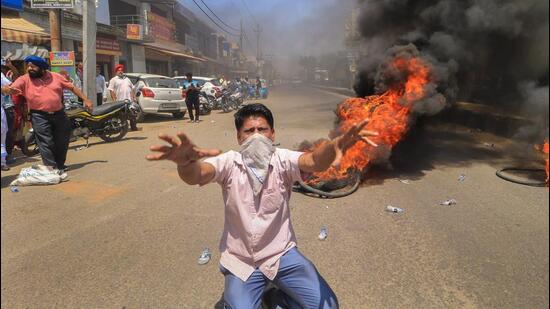 A man stages a protest over erratic power supply and shortage of drinking water in Jammu. (PTI)