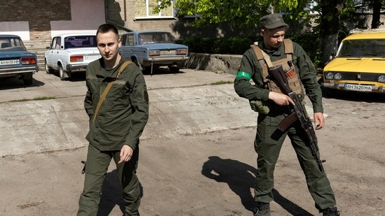 Ukraine servicemen walk next to a parking space full of Lada cars, amid Russia's invasion of Ukraine in Sloviansk, in Donetsk region, on April 27, 2022.&nbsp;(Reuters photo)