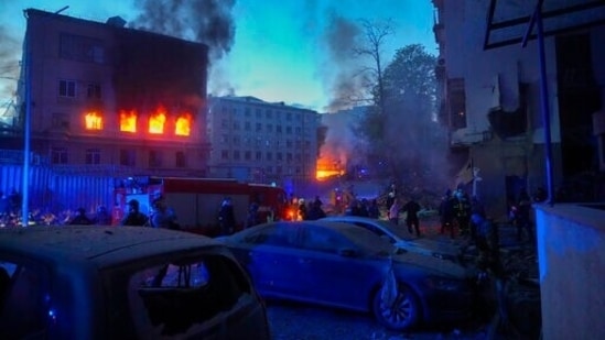 Firefighters put out a fire after a Russian rocket attack in Kyiv. Russia mounted attacks across a wide area of Ukraine on Thursday, bombarding Kyiv during a visit by the head of the United Nations.&nbsp;