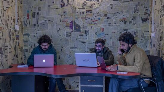 Fahad Shah (right), editor-in-chief of Kashmir Walla, works on his computer inside the newsroom at his office in Srinagar. (AP/FILE)
