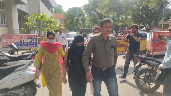 The accused woman student (C ) in police custody in Amritsar. She was arrested on Thursday along two others with a consignment of heroin. (HT Photo)