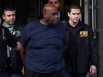 Frank James, the suspect in the Brooklyn subway shooting walks outside a police precinct in New York City.