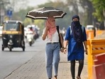 Women seen using scarves and umbrellas to protect themselves from the heat. (HT PHOTO) Women seen using scarves and umbrellas to protect themselves from the heat. (HT PHOTO)