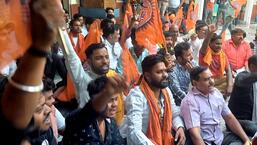 Activists of VHP and Bajrang Dal reciting Hanuman Chalisa at the office of DRM Agra on Friday. (HT PHOTO)