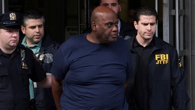 Frank James, the suspect in the Brooklyn subway shooting walks outside a police precinct in New York City. (Reuters)