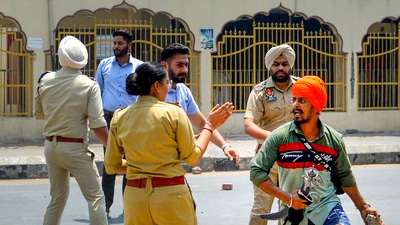 Security personnel attempt to maintain law and order after a clash broke out between followers of Shiv Sena and pro-Khalistani Sikh organisations, near Kali Mata Mandir in Patiala. (PTI) Security personnel attempt to maintain law and order after a clash broke out between followers of Shiv Sena and pro-Khalistani Sikh organisations, near Kali Mata Mandir in Patiala. (PTI)