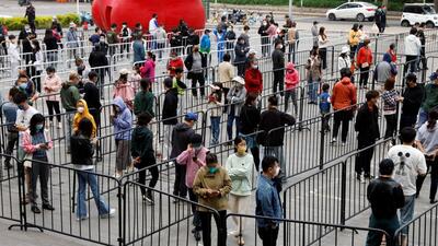 People line up at a makeshift nucleic acid testing site amid Covid-19 outbreak, in Chaoyang district of Beijing, China, on Friday. (REUTERS) People line up at a makeshift nucleic acid testing site amid Covid-19 outbreak, in Chaoyang district of Beijing, China, on Friday. (REUTERS)