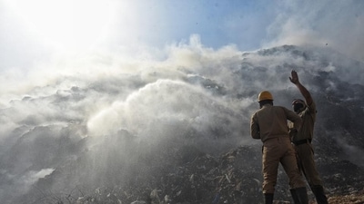 Firefighters douse a fire at Bhalswa landfill, in New Delhi. Firefighters douse a fire at Bhalswa landfill, in New Delhi.